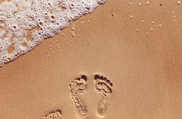 Footprints on the sand beach, vacation concept 