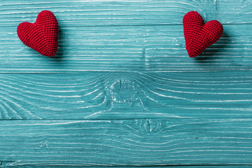 Knitted heart on a blue wooden background