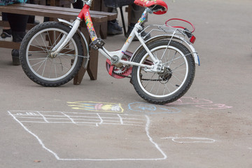 children's bicycle and chalk drawing on the playground