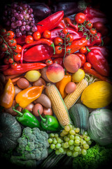 Fruits and vegetables overhead rainbow assortment colorful background green, yellow to red in studio. Vignetted vertical composition