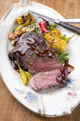 Barbecue wagyu chateaubriand with vegetable and maize as close-up on a plate