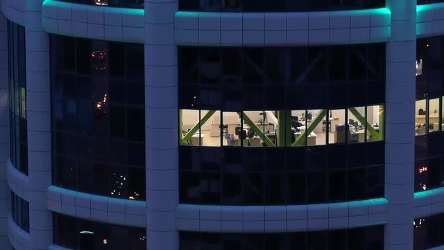 An empty night office in a building outside the window. Aerial photography from the street.  Russia, Novosibirsk, Kirova st., 2017-10-07