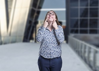 Fototapeta premium Pretty business woman making a smile gesture with glasses
