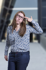 Fototapeta premium Pretty business woman making suicide gesture over blur background
