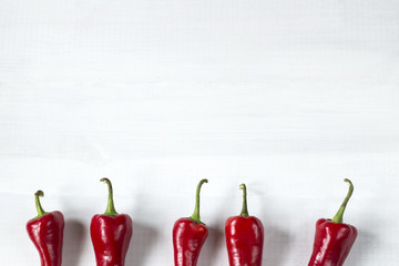 cayenne chilli peppers on wooden table