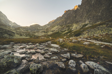 Creek in the Valley under the Mountain Peaks at Sunset. Velicka Valley, High Tatra, Slovakia.