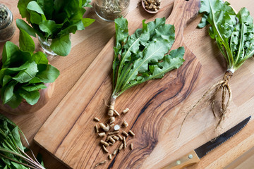 Cut-up dandelion root on a wooden cutting board