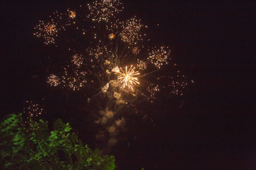 A photo of a salute in the night sky. Bright texture of festive fireworks. Abstract holiday background with various colors fireworks light. New Year's, Christmas lights in the sky, colorful lights.