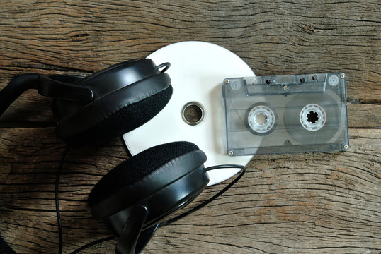 CD cassette tape and earphones on wooden floor