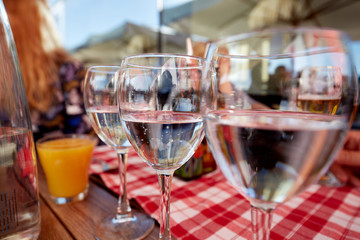 Row of pure drinking water glasses at summer terrace cafe.