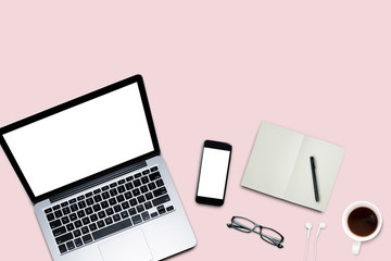 Top view, Working desk, computer, laptop, smart phone, coffee mug, glasses and notebooks on pastel color background with copyspace for text.