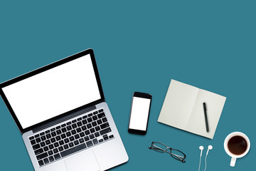 Top view, Working desk, computer, laptop, smart phone, coffee mug, glasses and notebooks on pastel color background with copyspace for text.