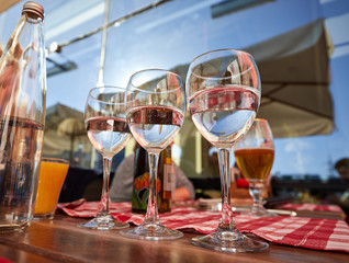 Row of pure drinking water glasses at summer terrace cafe.
