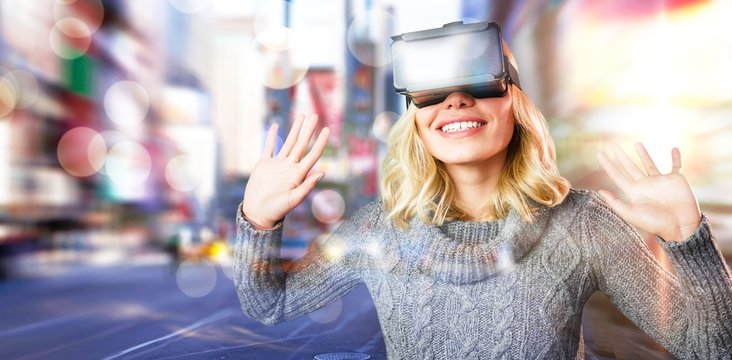 Composite image of cheerful young woman using reality virtual