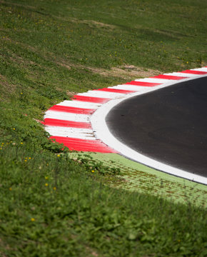 Motorsport racing track curb at round closeup closeup limit borderline concept