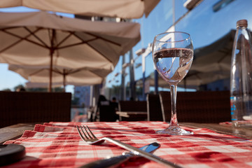 Pure drinking water glass at summer terrace cafe.