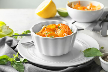 Dish with tasty carrot salad on table