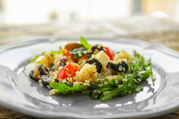 Plate with quinoa salad on table, closeup