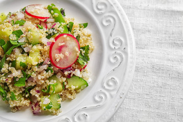 Salad with quinoa and vegetables on plate, closeup