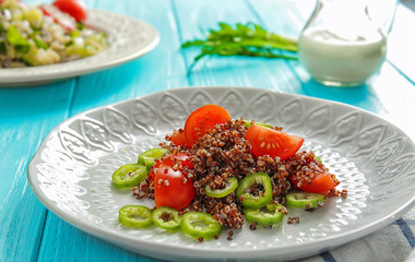 Plate with quinoa salad on table, closeup