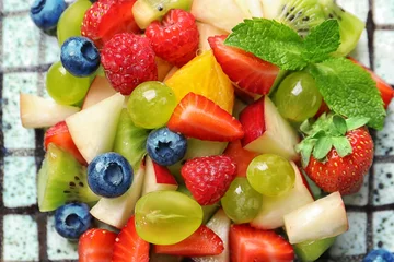 Tuinposter Plate with fruit salad, closeup © Africa Studio