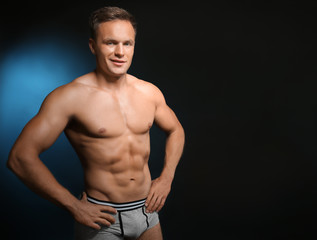Fototapeta premium Muscular man in underwear on dark background