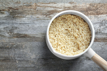 Cooked rice in saucepan on table