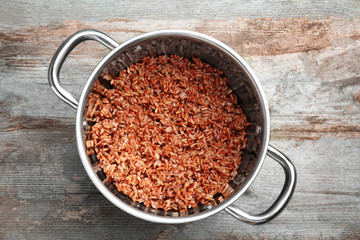 Cooked rice in saucepan on table