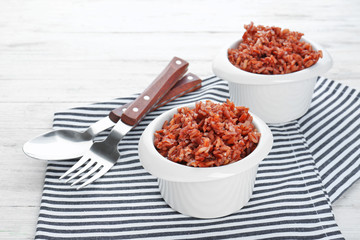 Ramekins with cooked rice on table