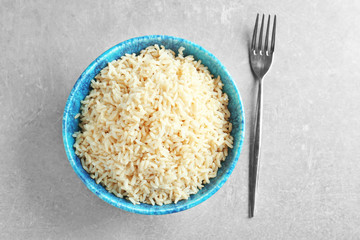 Dish with cooked rice on table