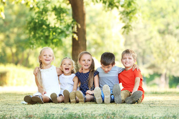 Naklejka na ściany i meble Group of children in park on sunny day