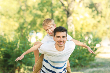 Father with son in park on sunny day