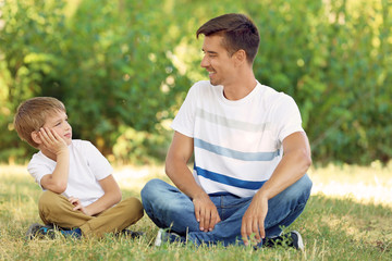 Father with son in park on sunny day