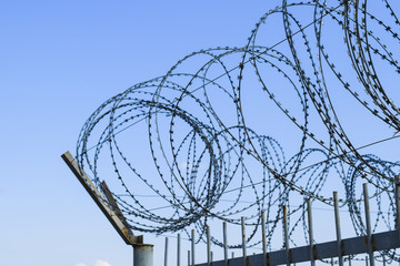Barbed wire on the fence. Protective fencing specially protected