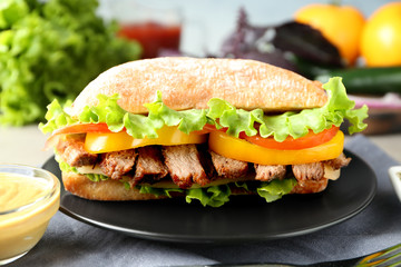 Plate with steak sandwich on table