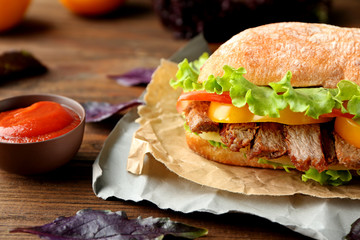 Tasty steak sandwich on table