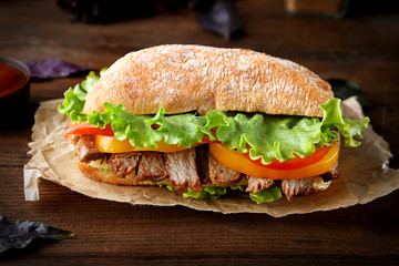Tasty steak sandwich on table