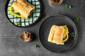 Plates with steak sandwiches on table