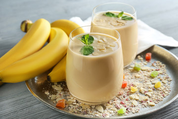 Composition with tasty banana smoothie on table