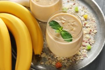 Glass of tasty banana smoothie on table