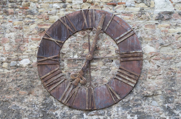 Old clock on the stone wall