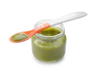 Plastic spoon and jar with baby food on white background