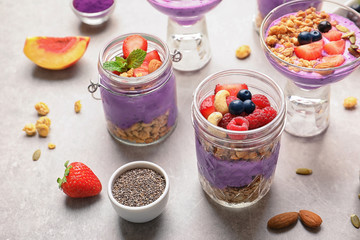 Composition of healthy breakfast with delicious acai smoothie on light background