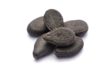 Fototapeta na wymiar Close up pile of black sesame seeds isolated on white background