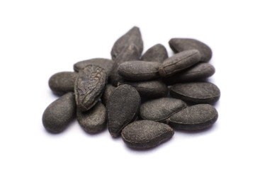 Close up pile of black sesame seeds isolated on white background