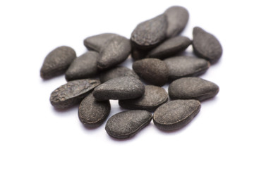 Close up pile of black sesame seeds isolated on white background