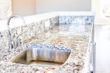 New modern faucet and kitchen sink closeup with granite countertops - obrazy, fototapety, plakaty