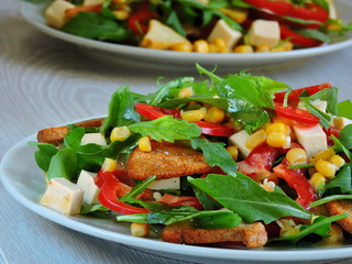 Two plates with a vegetarian salad. Fitness salad with arugula and corn. Fitness salad for weight reduction.