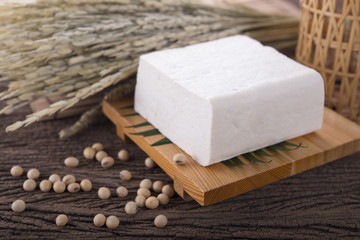 square tofu on plate and on wooden background