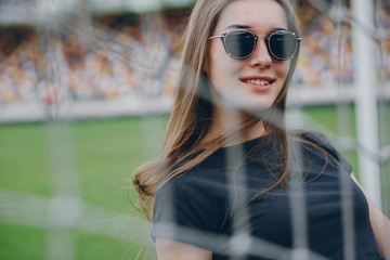 girl standing next to a net